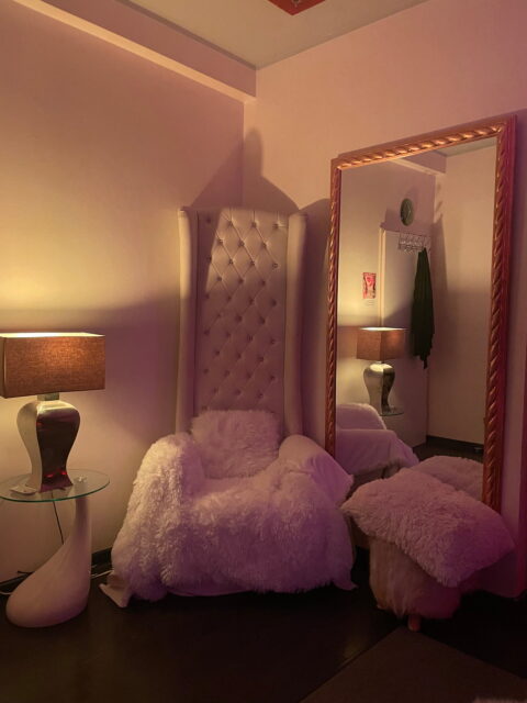 Ein Stuhl in einem Raum mit einem Spiegel.